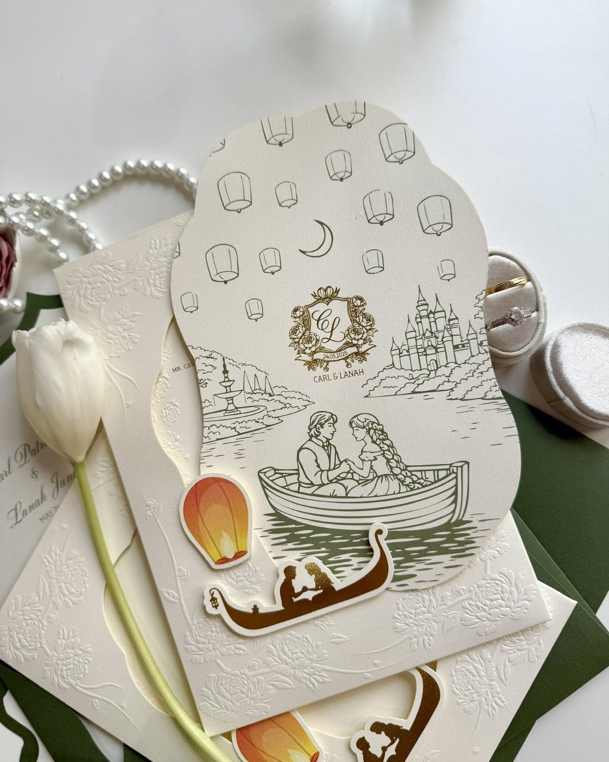 Disney Tangled wedding invitations with a boat illustration, white tulip, and pearls.