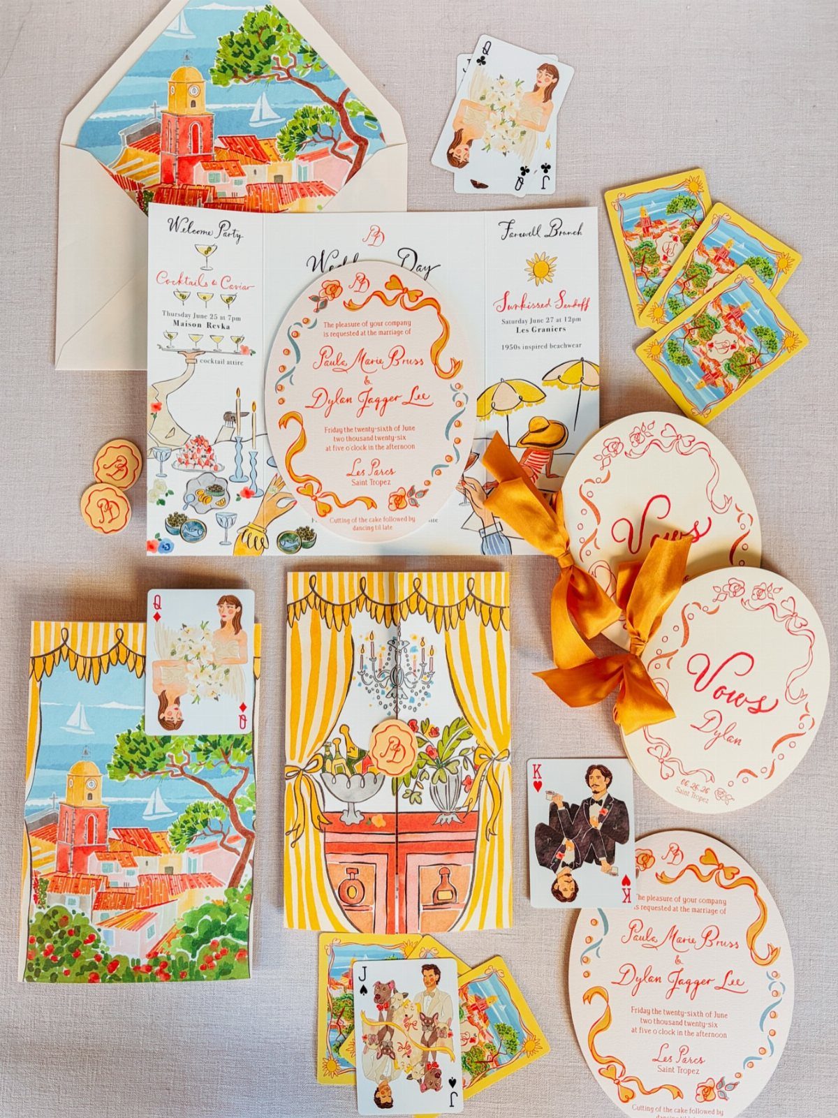 Wedding invitation suite with colorful Mediterranean illustrations, custom playing cards, and orange ribbons.