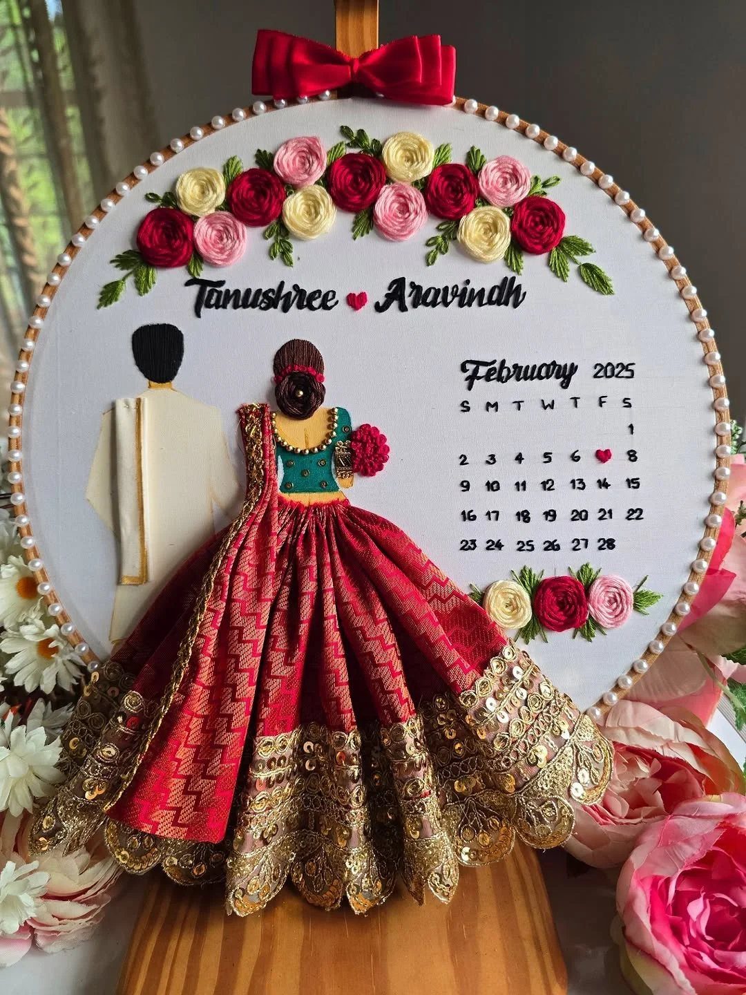 Customized wedding gift hoop featuring 3D fabric couple, floral accents, and a calendar.