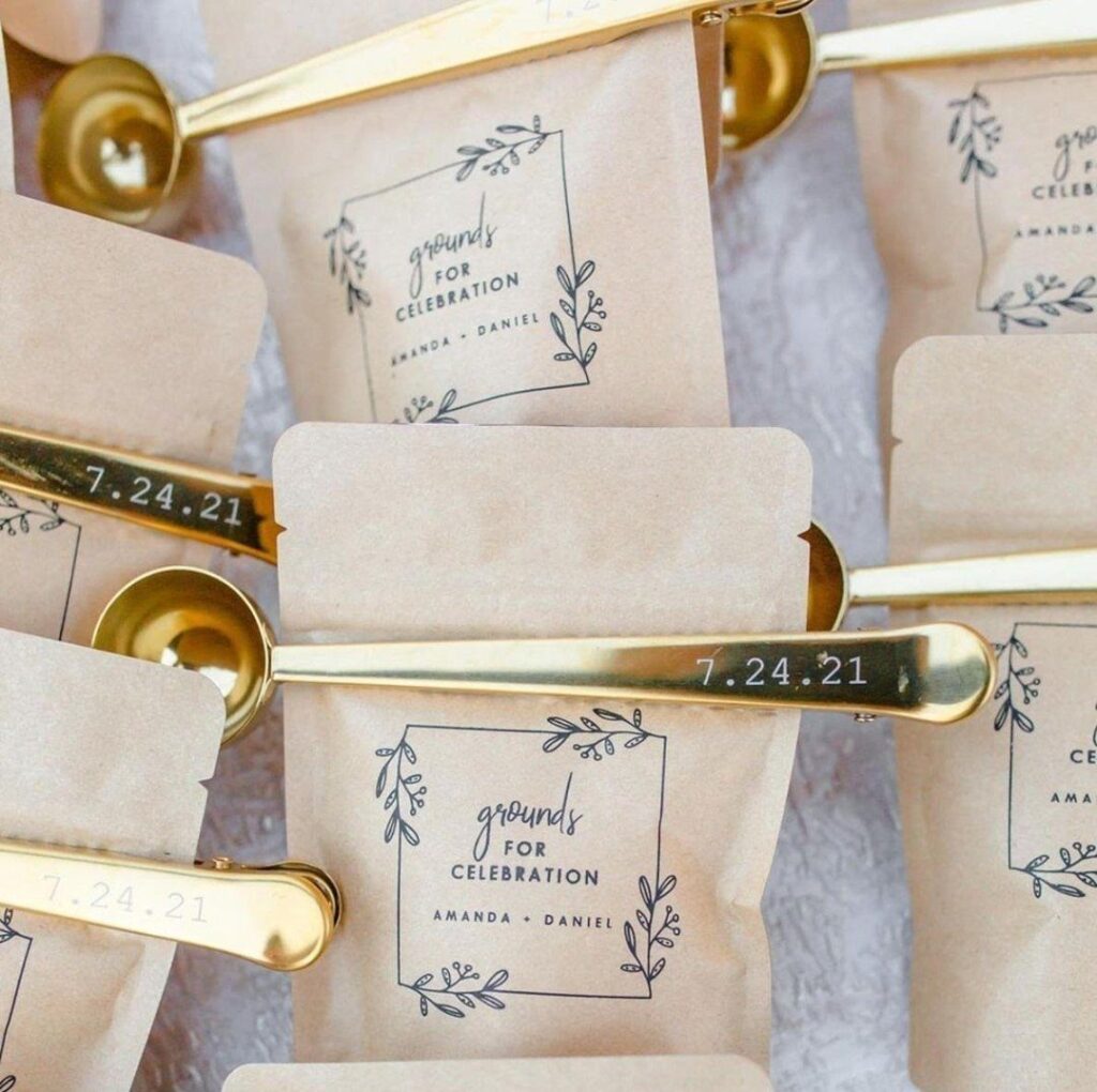 Brown coffee bags with personalized labels and gold metal scoops engraved with a date.