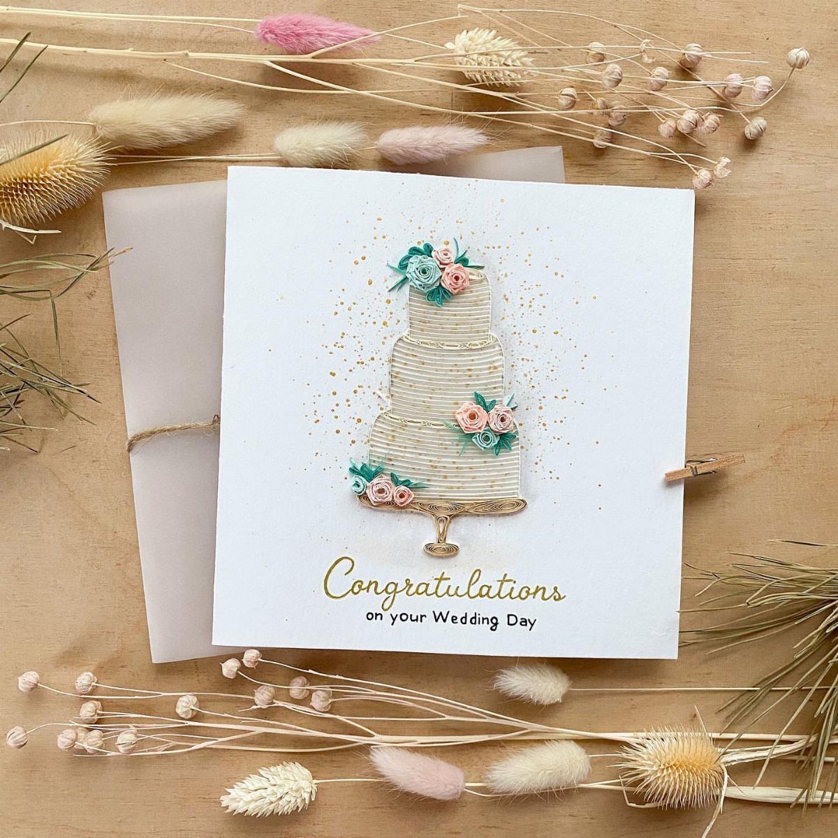 Wedding congratulations card with a 3D cake design and dried floral accents.