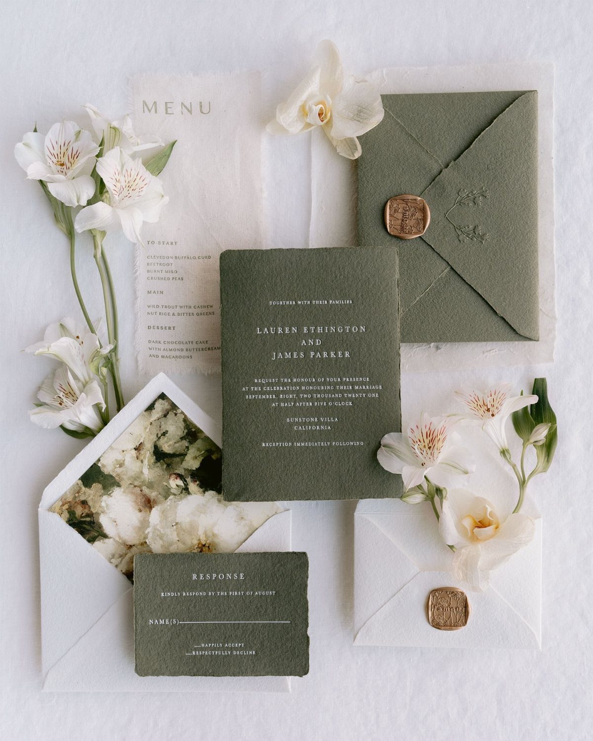 Olive green wedding invitation suite with wax seals and white floral accents