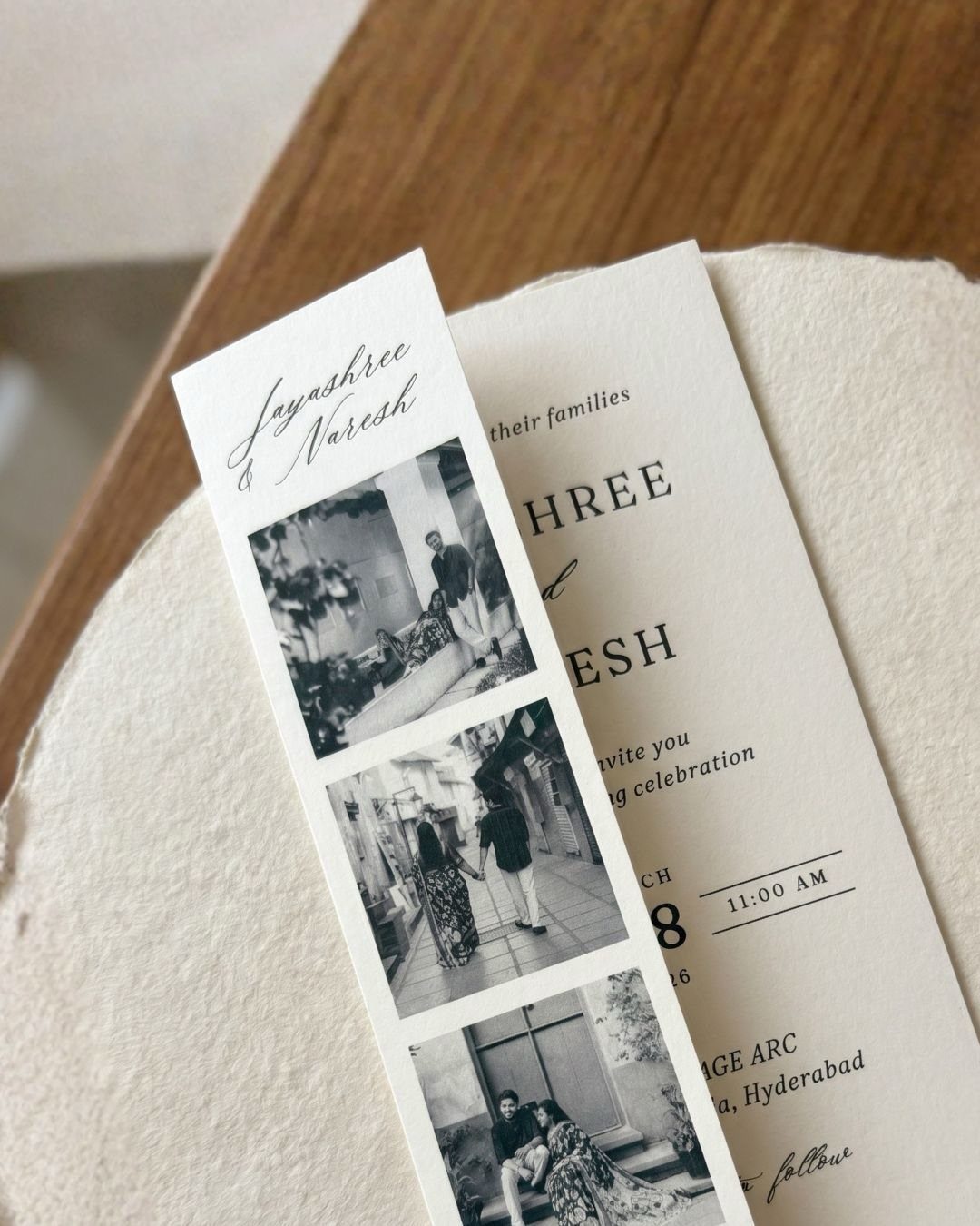 Minimalist wedding invitation with a black and white photo strip of a couple.
