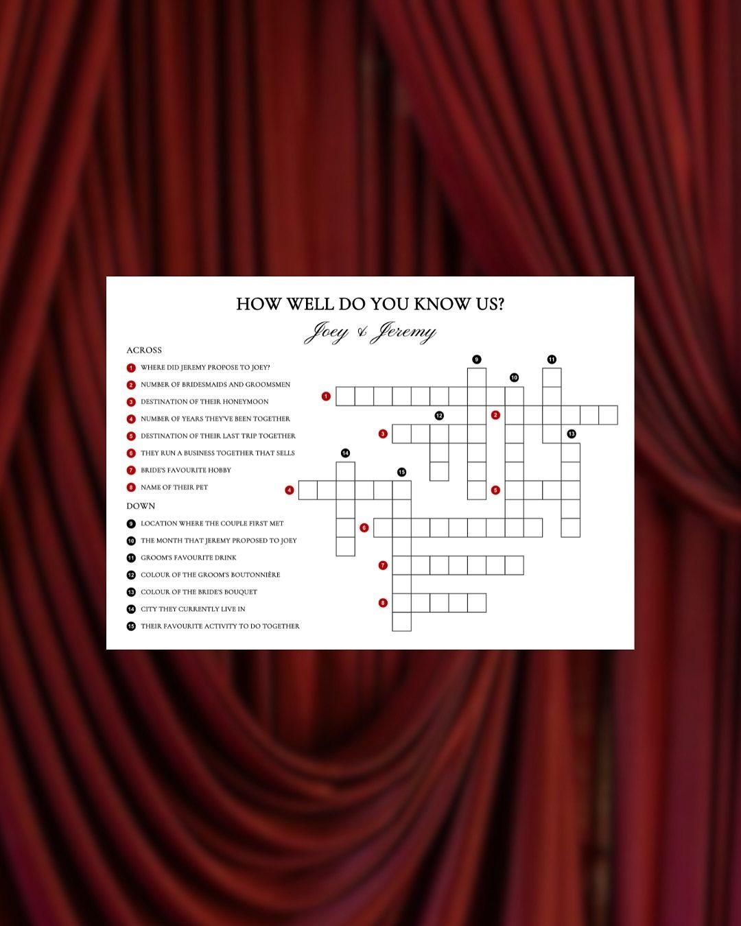 Crossword puzzle card for a wedding placed against red draped fabric background.