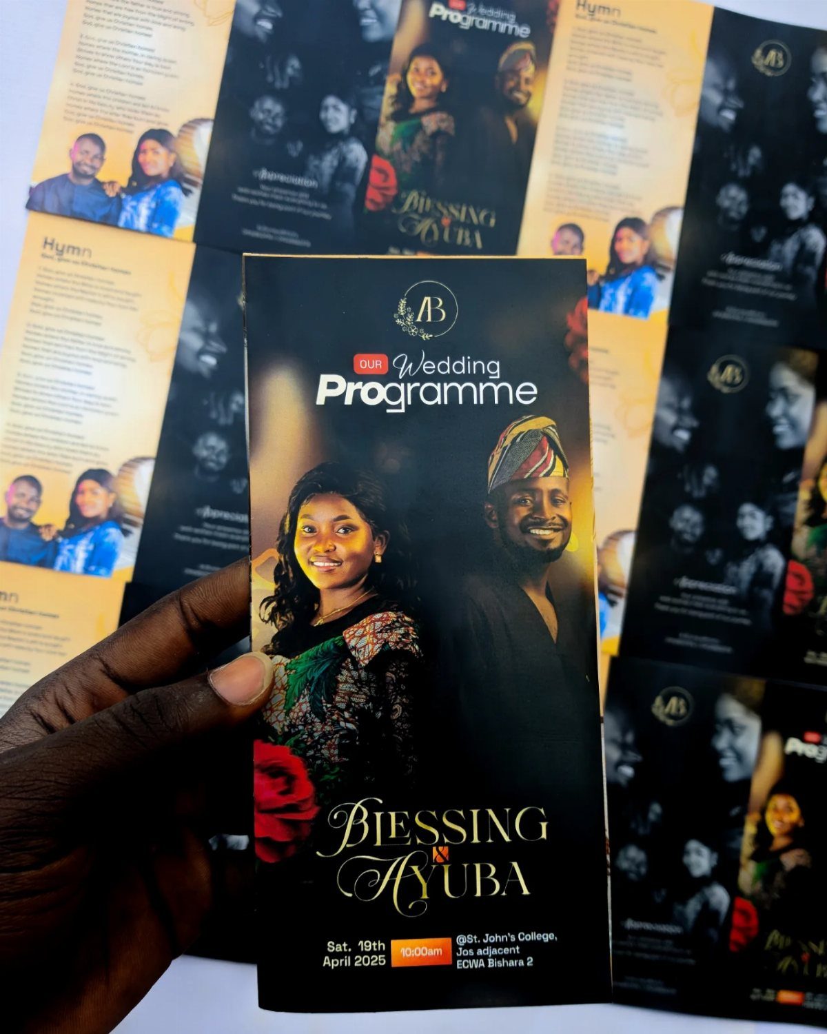 Wedding program held by a hand featuring a couple's photo and event details.