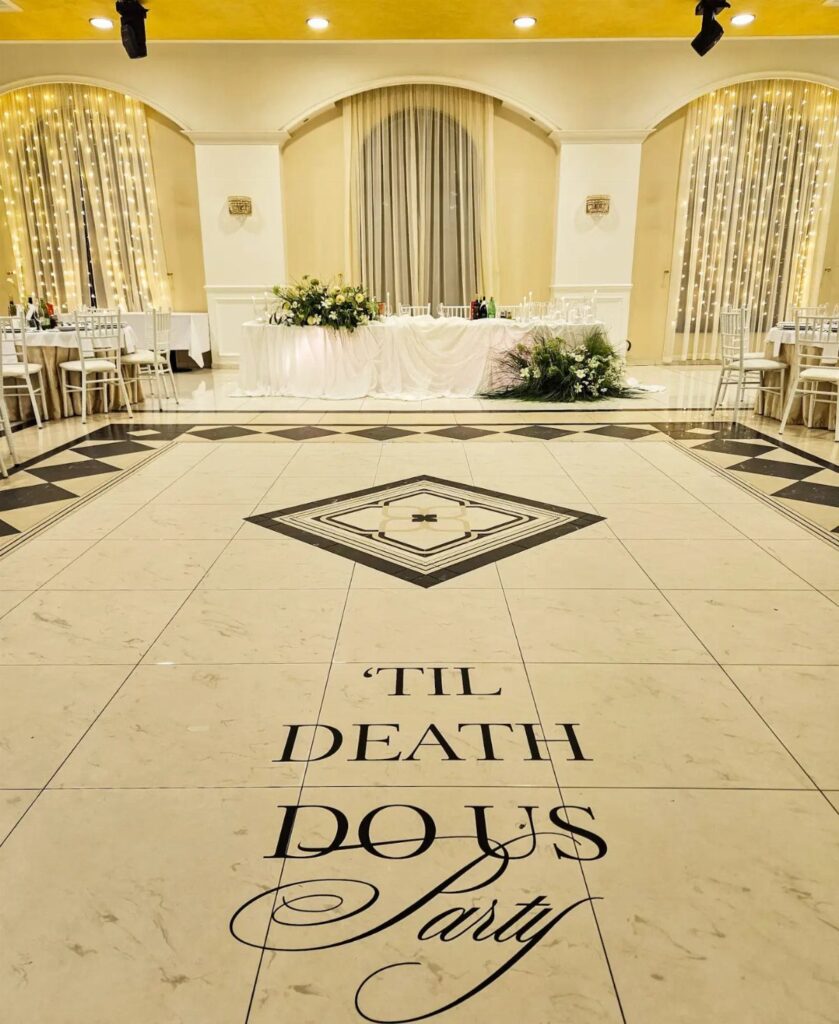 White dance floor with Til Death Do Us Party text in a wedding venue