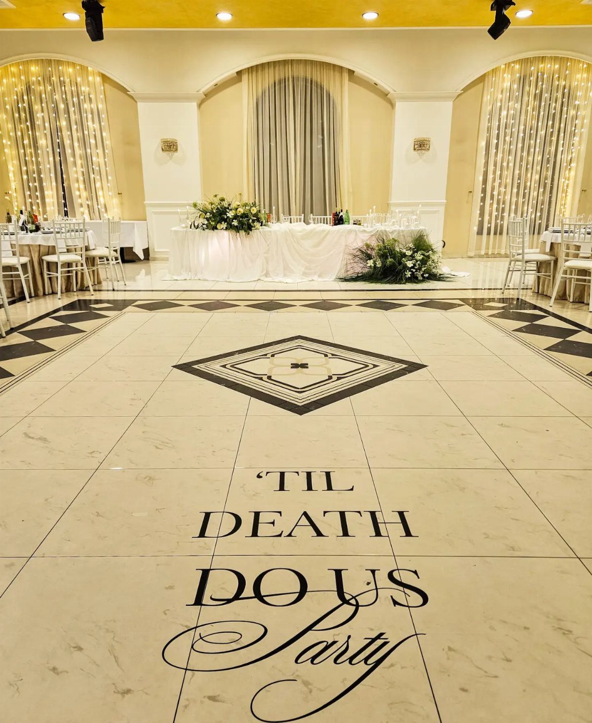 White dance floor with Til Death Do Us Party text in a wedding venue