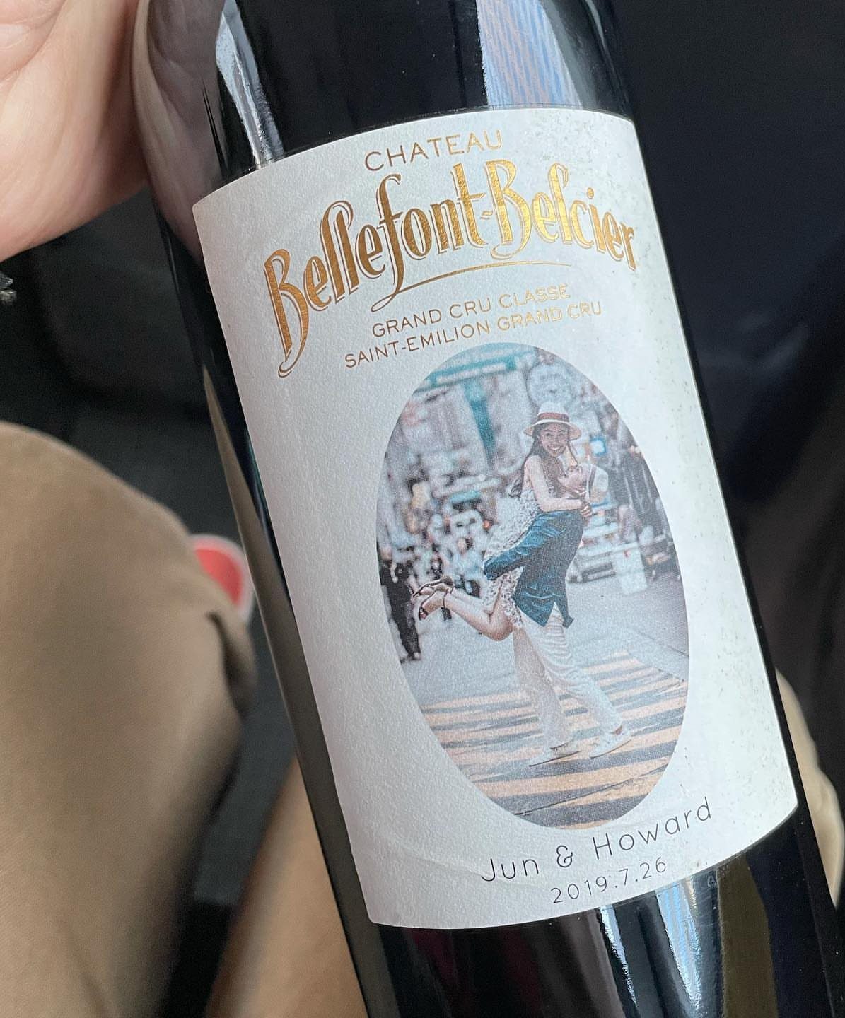 Wine bottle with a custom wedding label featuring a couple's photo and names.